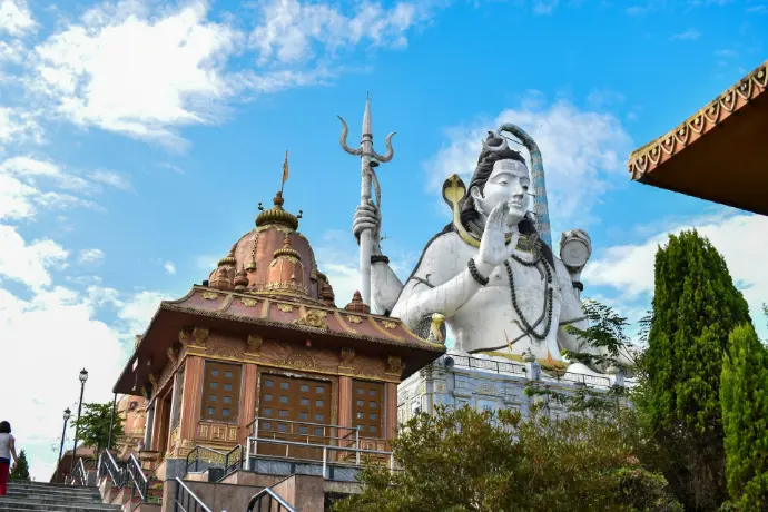 a statue of a god on top of a building